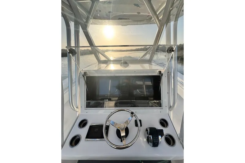  Yacht Photos Pics 2017 SeaHunter 35 Tournament helm with steering wheel, controls, and sunset view.