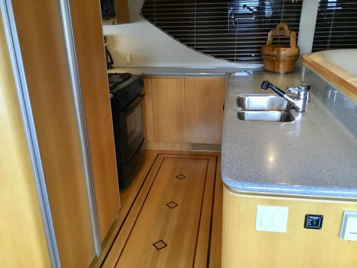 "southern Cross" Yacht Photos Pics 1998 West Bay Sonship yacht kitchen with wood cabinetry and modern appliances.