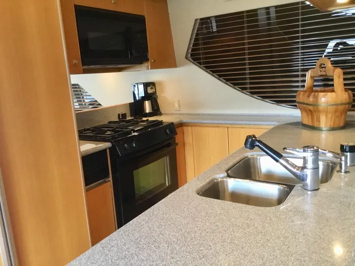 "southern Cross" Yacht Photos Pics Kitchen interior of 1998 West Bay Sonship yacht with modern appliances and sleek design.