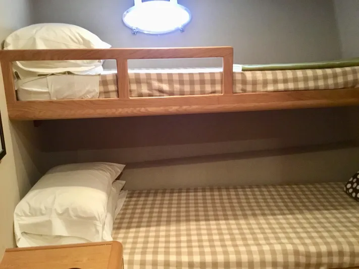 "southern Cross" Yacht Photos Pics Bunk beds with checkered bedding in a 1998 West Bay Sonship yacht cabin.