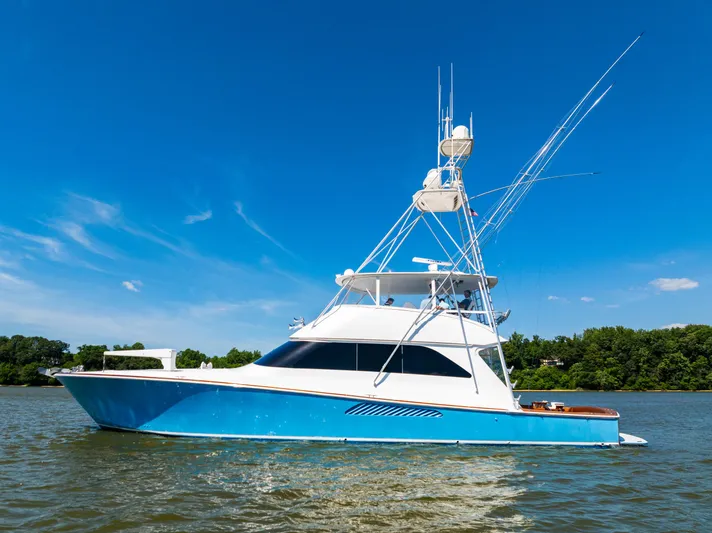 Second Generation Yacht Photos Pics 2006 Viking 68 Convertible yacht cruising on a sunny day with clear blue skies.