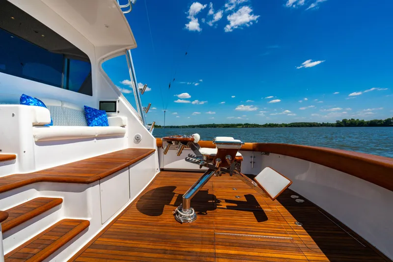 Second Generation Yacht Photos Pics Luxurious 2006 Viking 68 Convertible yacht deck with wooden flooring and scenic water view.