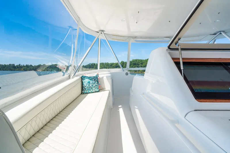 Second Generation Yacht Photos Pics Luxurious 2006 Viking 68 Convertible yacht interior with white seating and scenic water view.