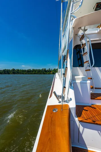 Second Generation Yacht Photos Pics 2006 Viking 68 Convertible yacht on water, featuring sleek design and wooden deck.