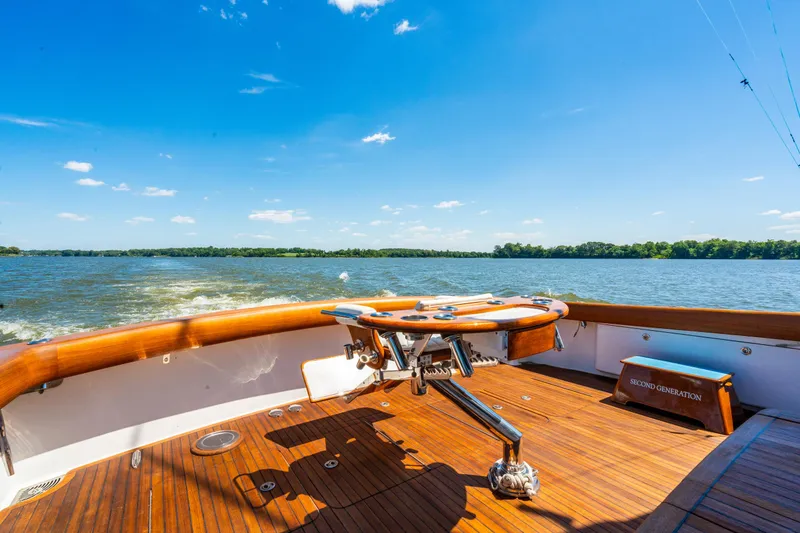 Second Generation Yacht Photos Pics 2006 Viking 68 Convertible yacht deck with scenic water view and clear blue sky.