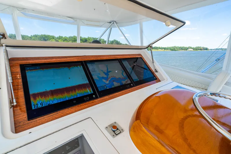 Second Generation Yacht Photos Pics Helm of 2006 Viking 68 Convertible yacht with navigation screens and scenic water view.