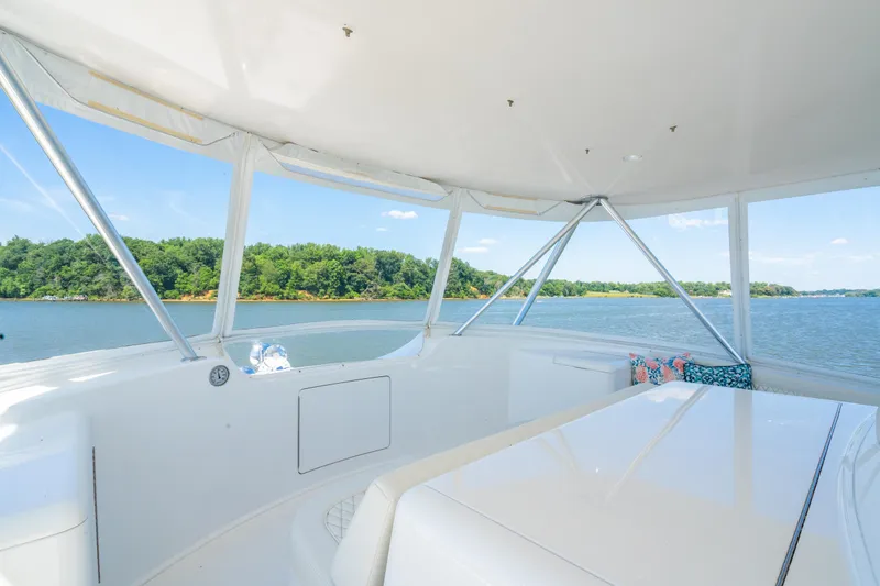 Second Generation Yacht Photos Pics 2006 Viking 68 Convertible yacht interior with scenic water view and lush greenery.