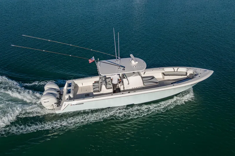 Wunderbar Yacht Photos Pics 2022 Contender 39 ST boat cruising on open water, side view.