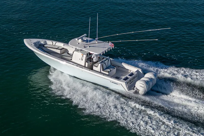 Wunderbar Yacht Photos Pics 2022 Contender 39 ST boat cruising on open water, showcasing sleek design and powerful engines.