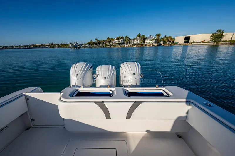 Wunderbar Yacht Photos Pics 2022 Contender 39 ST boat with triple outboard engines on calm water.