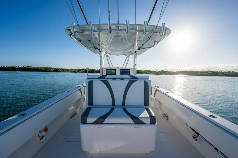 Wunderbar Yacht Photos Pics 2022 Contender 39 ST boat interior with seating, on calm water at sunrise.