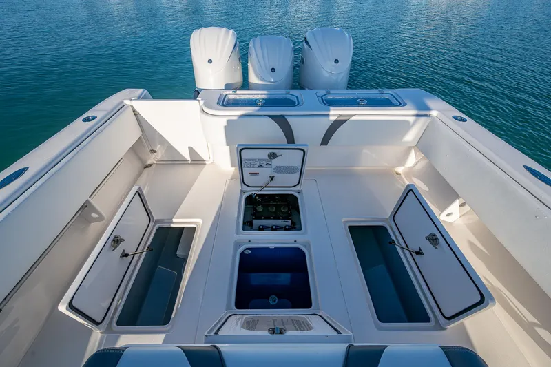 Wunderbar Yacht Photos Pics 2022 Contender 39 ST boat deck with open storage compartments and triple outboard engines.
