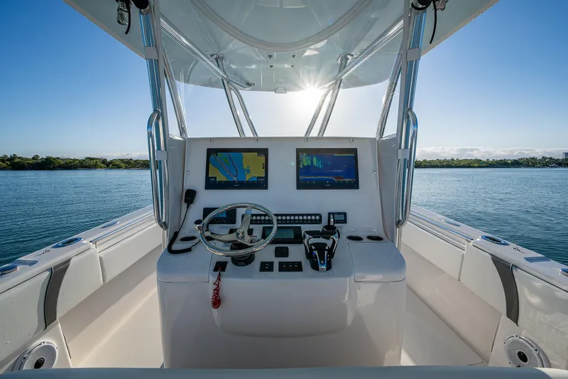 Wunderbar Yacht Photos Pics 2022 Contender 39 ST boat helm with dual screens on calm water.