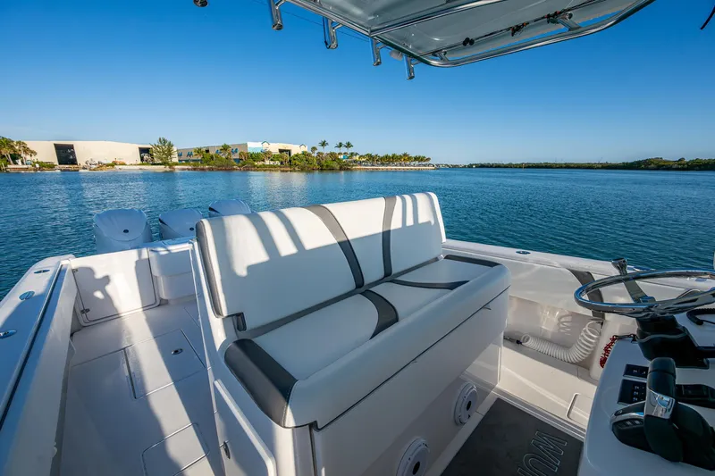 Wunderbar Yacht Photos Pics 2022 Contender 39 ST boat interior with seating, steering wheel, and scenic water view.