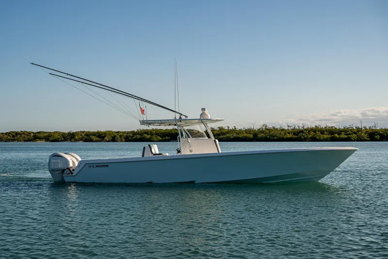 Wunderbar Yacht Photos Pics 2022 Contender 39 ST boat on calm water, side view, clear sky background.