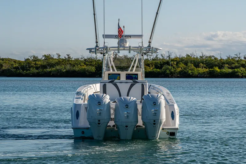 Wunderbar Yacht Photos Pics 2022 Contender 39 ST boat with triple outboard engines on calm water.