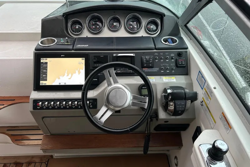  Yacht Photos Pics 2014 Sea Ray 350 Sundancer helm with navigation display and control panel.