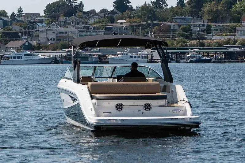  Yacht Photos Pics 2019 Sea Ray SLX 280 boat cruising on a scenic waterfront with houses in the background.