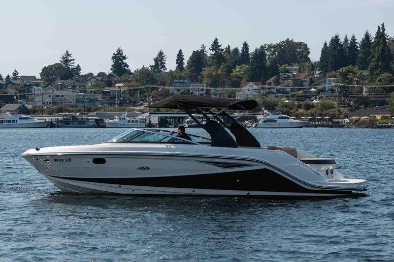  Yacht Photos Pics 2019 Sea Ray SLX 280 boat cruising on a scenic lake with houses in the background.