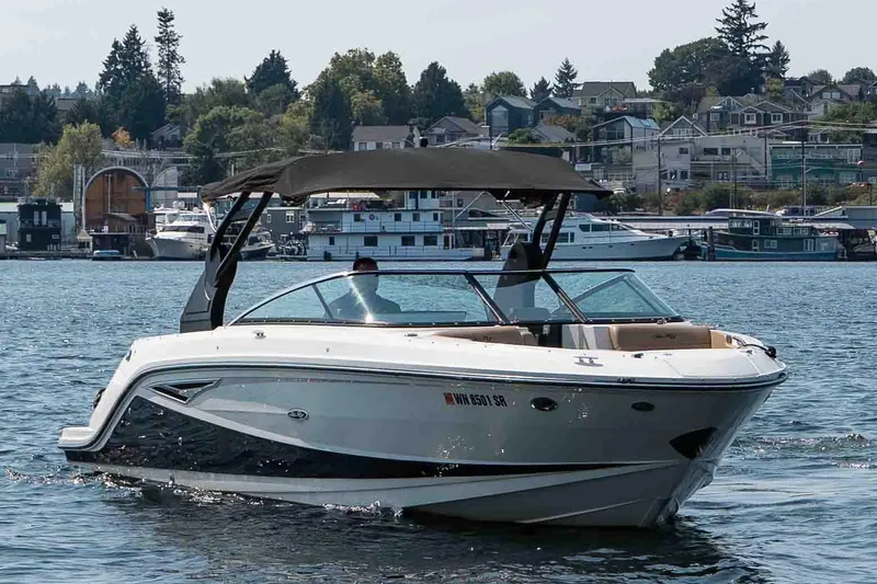  Yacht Photos Pics 2019 Sea Ray SLX 280 boat cruising on a scenic lake with houses in the background.