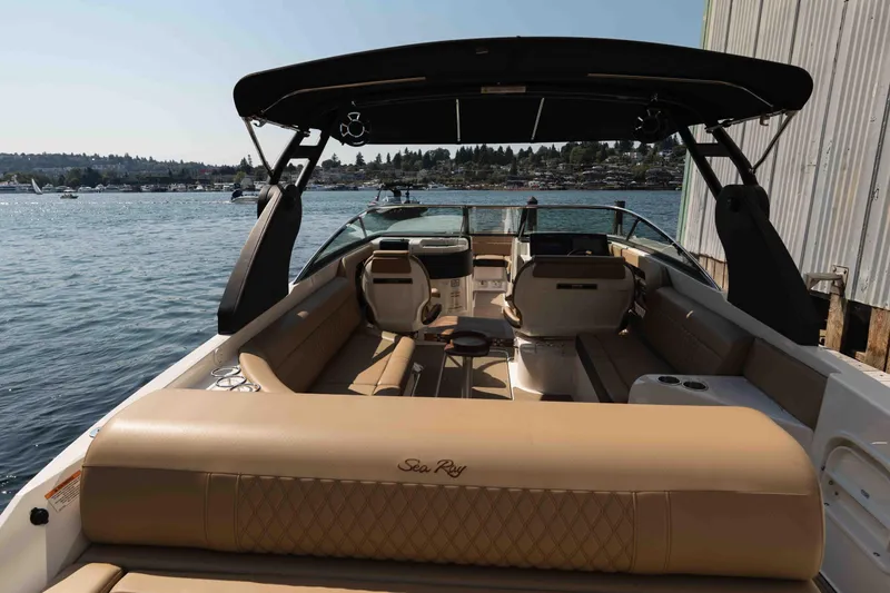  Yacht Photos Pics 2019 Sea Ray SLX 280 boat with tan interior, docked by a scenic waterfront.