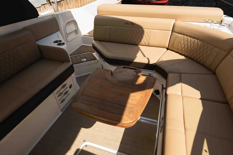  Yacht Photos Pics Interior of 2019 Sea Ray SLX 280 boat with tan leather seating and wooden table.