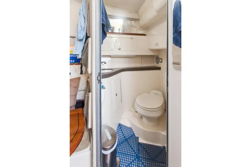 Pole Position Yacht Photos Pics 2006 Grady-White Express 330 boat bathroom interior with toilet and storage.