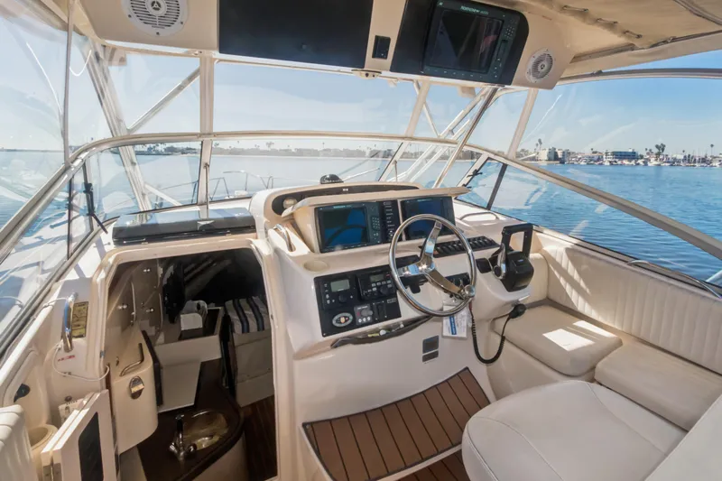 Pole Position Yacht Photos Pics 2006 Grady-White Express 330 boat interior with helm, steering wheel, and navigation equipment.