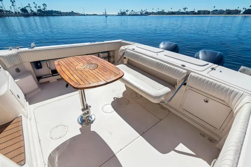 Pole Position Yacht Photos Pics 2006 Grady-White Express 330 boat interior with wooden table and seating.