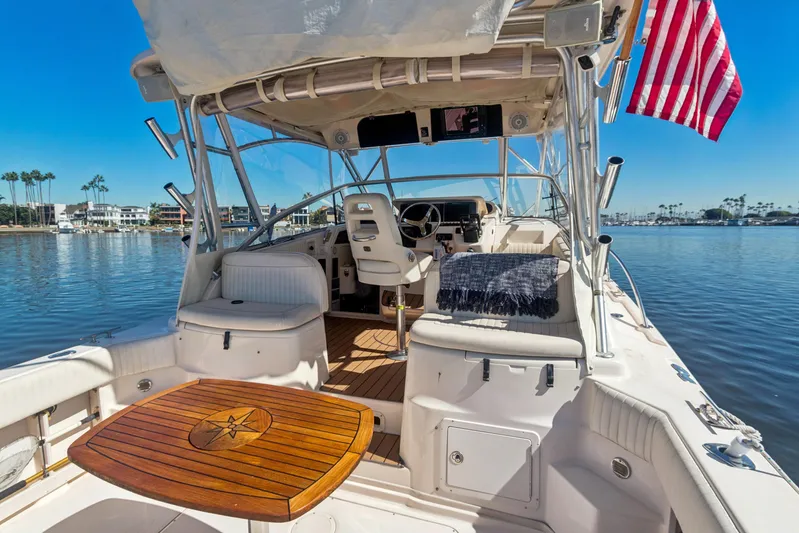 Pole Position Yacht Photos Pics 2006 Grady-White Express 330 boat interior with American flag, docked on calm water.