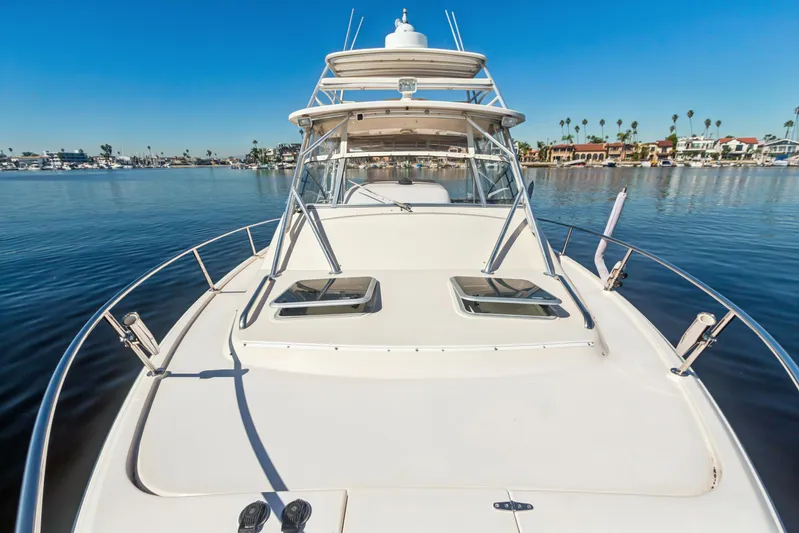 Pole Position Yacht Photos Pics 2006 Grady-White Express 330 boat on calm water, clear sky, coastal background.