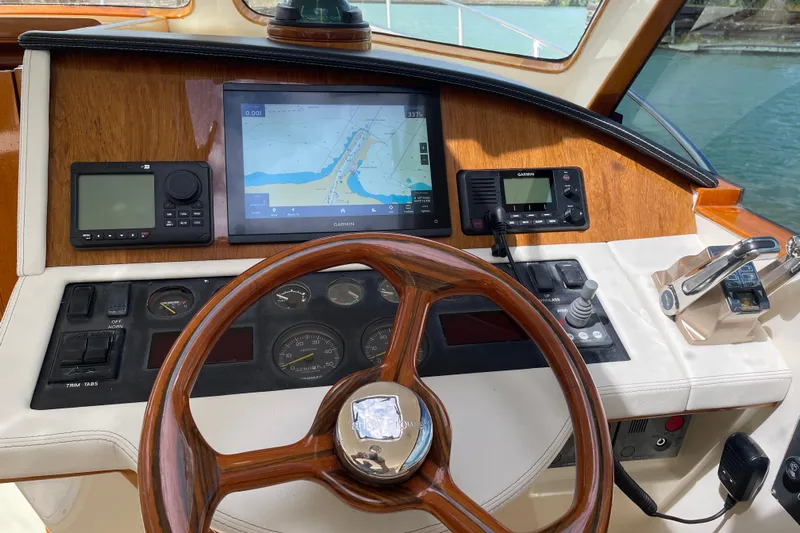  Yacht Photos Pics Helm of 2006 Marlow 375 Prowler Classic with navigation equipment and wooden steering wheel.