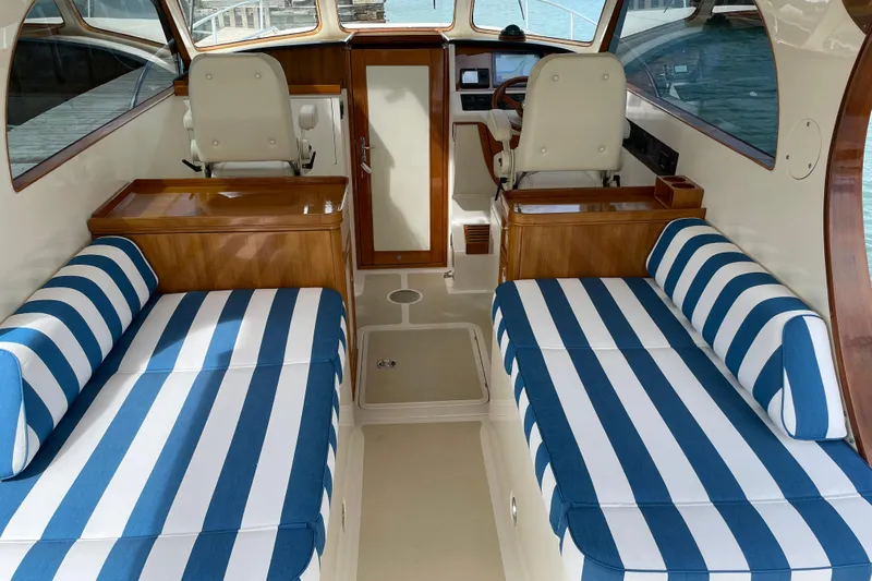  Yacht Photos Pics Interior of 2006 Marlow 375 Prowler Classic with striped seating and wooden accents.