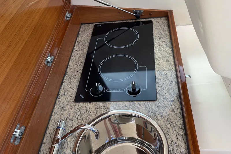  Yacht Photos Pics 2006 Marlow 375 Prowler Classic kitchen with electric stove and sink on granite countertop.