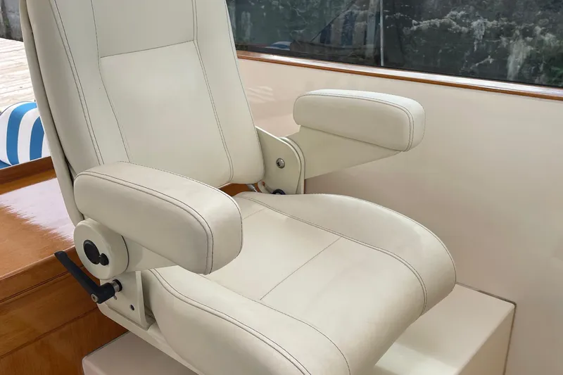  Yacht Photos Pics Captain's chair on 2006 Marlow 375 Prowler Classic yacht, featuring white leather upholstery.