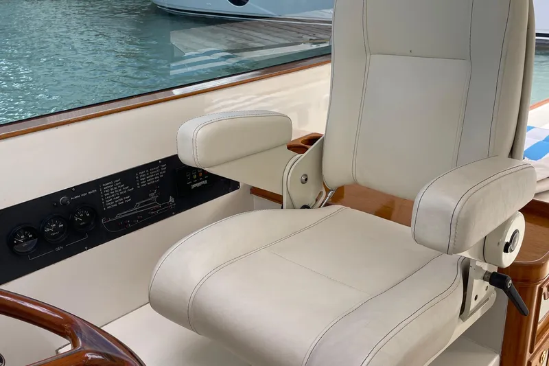  Yacht Photos Pics Captain's chair on 2006 Marlow 375 Prowler Classic yacht, with control panel and water view.