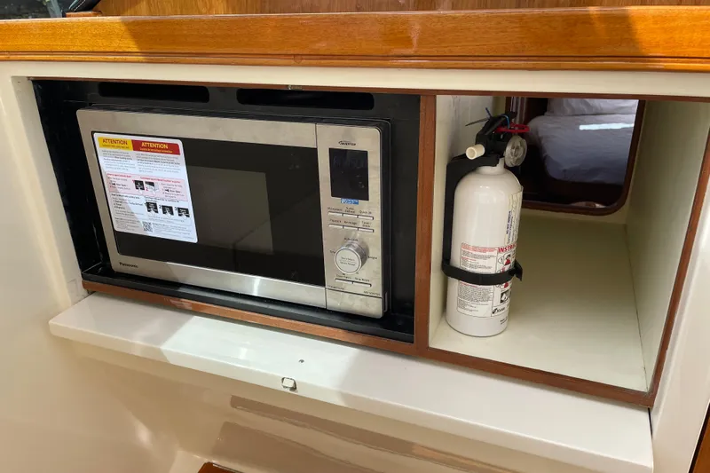  Yacht Photos Pics Microwave and fire extinguisher in 2006 Marlow 375 Prowler Classic yacht interior.