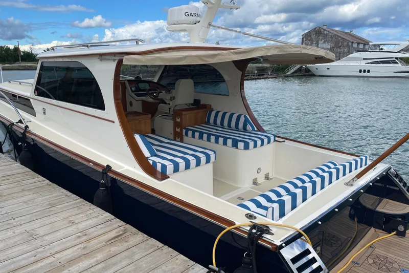  Yacht Photos Pics 2006 Marlow 375 Prowler Classic yacht docked, featuring striped seating and sleek design.