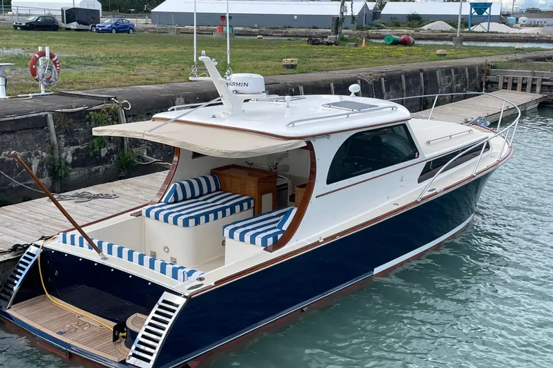  Yacht Photos Pics 2006 Marlow 375 Prowler Classic yacht docked, featuring striped seating and elegant design.