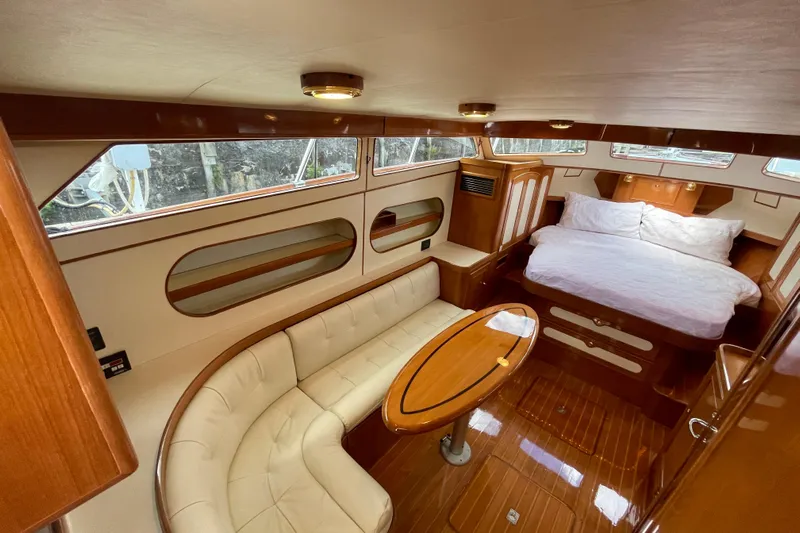  Yacht Photos Pics Luxurious interior of 2006 Marlow 375 Prowler Classic yacht with cozy seating and bed.