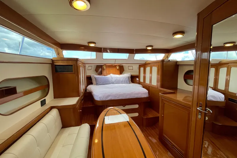  Yacht Photos Pics Luxurious interior of 2006 Marlow 375 Prowler Classic yacht with wood finishes and cozy bed.