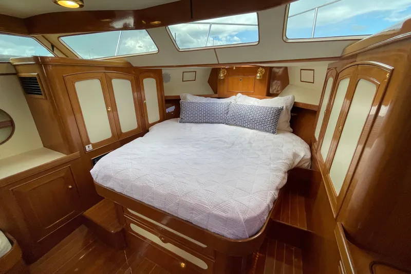  Yacht Photos Pics Luxurious cabin interior of 2006 Marlow 375 Prowler Classic yacht with elegant wood finish.