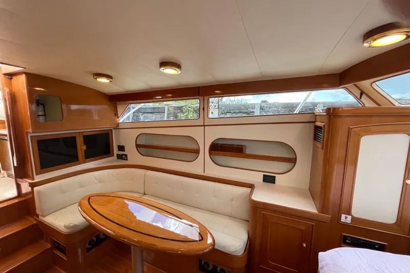  Yacht Photos Pics Interior of 2006 Marlow 375 Prowler Classic yacht with elegant wood finish and seating area.