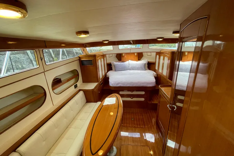 Yacht Photos Pics Luxurious interior of 2006 Marlow 375 Prowler Classic yacht with wood finishes and cozy seating.