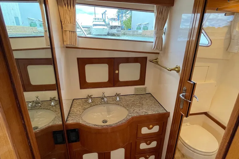  Yacht Photos Pics Luxurious bathroom in 2006 Marlow 375 Prowler Classic yacht with elegant wood and granite finishes.