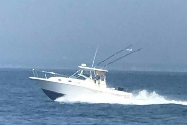 2002 Stamas 340 Express boat cruising on open water.