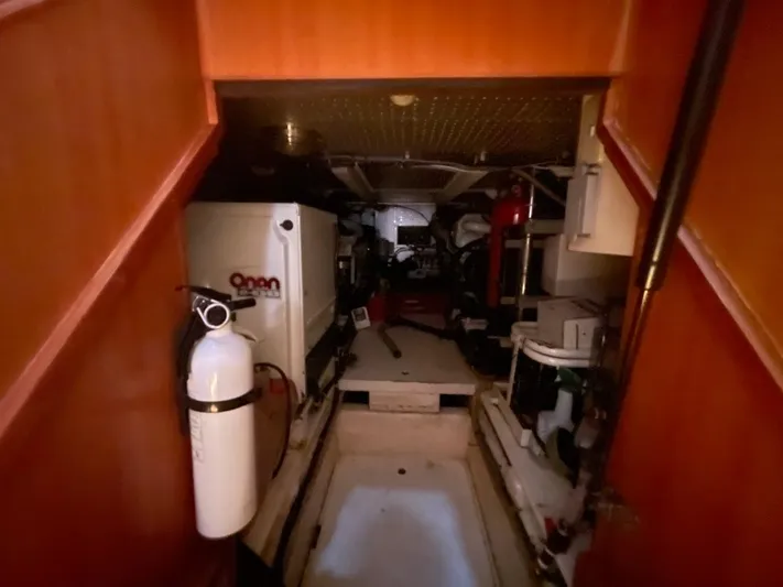 The Lucky Dreamers Yacht Photos Pics Engine room of 2005 Novatec 48 Cockpit Motor Yacht with Onan generator and fire extinguisher.