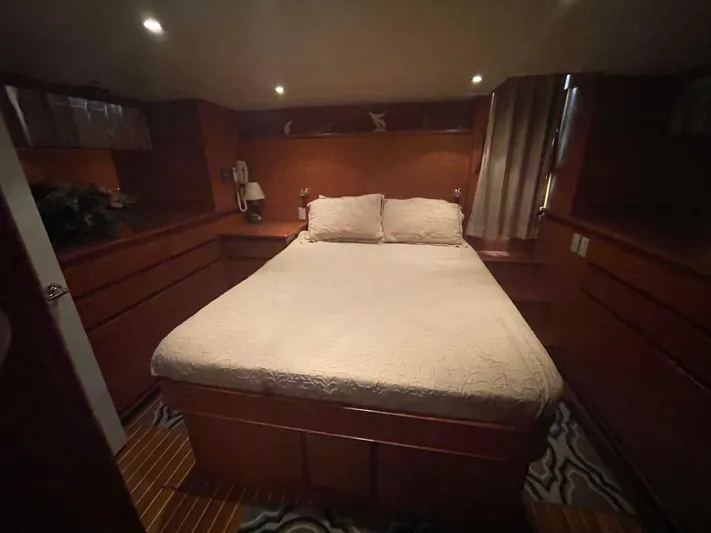 The Lucky Dreamers Yacht Photos Pics Luxurious bedroom interior of 2005 Novatec 48 Cockpit Motor Yacht with cozy lighting.