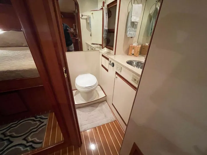The Lucky Dreamers Yacht Photos Pics Bathroom interior of 2005 Novatec 48 Cockpit Motor Yacht with wooden flooring.