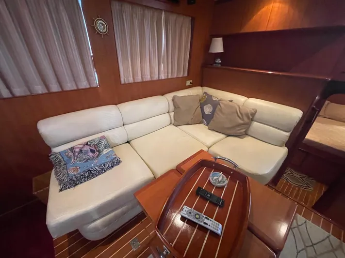 The Lucky Dreamers Yacht Photos Pics Luxurious interior of 2005 Novatec 48 Cockpit Motor Yacht with plush seating and wooden accents.